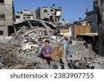 Small photo of Palestinians inspect their destroyed house after an Israeli air strike, in the city of Rafah, south of the Gaza Strip, on November 4, 2023.