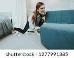 Small photo of Young Woman Moves The Sofa In The New Apartment. Reshuffle In The Room Concept. Domestic Problems. Clean Residence. Powerful Girl. Try Hard. Power Girl. Changes In The Living Room.