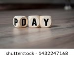 Cubes and dice with payday on wooden background