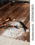 Small photo of renovation of a house, remove a glued parquet with tools to redo the floor