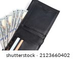 Small photo of Black leather wallet with stack hundred dollar bills and bank cards on white background.Concept wealth and affluence