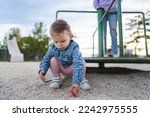 Small photo of One girl small caucasian child female toddler 18 months old in park play in day by speedy spinner merry-go-round turnabout childhood and growing up concept copy space