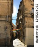 Small photo of Colorful stripes on the street of Enna, Sicily