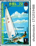 Small photo of 02.09.2020 Divnoe Stavropol Territory Russia postage stamp Equatorial Guinea 1972 Olympic Games - Munich, Germany Events in Kiel Finndinghy sailing yacht with a yachtsman