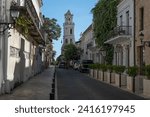 Small photo of Small street with old crumbling buildings of Spanish conquistador times at Zona Colonial historical Center in Santo Domingo, Dominican Republic.