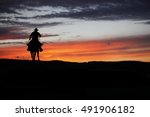 Cowboy Silhouette On A Horse...