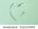 Cosmetic gel in shape of heart on the mint background.Copy space for text,mockup concept.