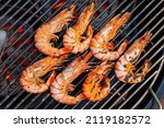 Small photo of Grilled shrimp that's being cooked with smoke on the grill.
