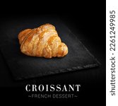 Small photo of Side view of traditional French croissant isolated on black background. Ready square menu banner with text and copy space. Fresh dessert on top served on slave board