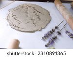 Creation of stencil ceramics with flowers and leaves of lavender and other plants by pressing on the table