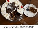 Small photo of Chocolate birthday cake with chocolate ganache icing. leftover birthday cake. leftover and wasted food. food waste. leftover food