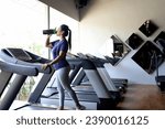 Small photo of Asian woman with beautiful face drinking water on treadmill machine. drink supplement drinks when exercising.bcaa, pre-workout drink, protein drink, whey protein milk concept.