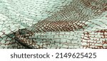 Small photo of python skin silk fabric, brown pattern, african theme, fulvous, lurid, grayish-brown. Texture. Background.
