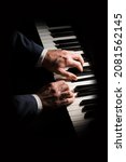 Small photo of Pianist plays chord on piano with both hands. Touches gently the keyboard. White, male, mature hands.