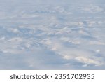 Small photo of Aerial view of snow-capped mountains and clouds. Winter snowy mountain landscape. Icheghem Range, Kolyma Mountains. Koryak Okrug (Koryakia), Kamchatka Krai, Siberia, Far East Russia. Great background.