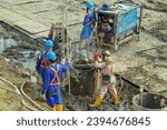 Small photo of Workers is welding metal parts of concrete bridge. Welding rebar in preparation for casting in the foundation hole. Series of secant pile work processes.