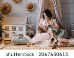 Mother and daughter spend time together. Mother's love. Teenager girl children's room. Hugs and care. mom and 10-year-old girl. Christmas Eve. Decorated room stylish interior cosiness. Happy New Year
