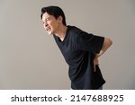 Small photo of Japanese man complaining of lower back pain