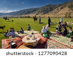 Small photo of Saty townsfolk gathered for a picnic in pasture by the Chilik river and Kungey Alatau mountains Saty, Kazakhstan - September 7, 2016