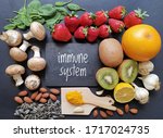 Assortment of food to naturally boost immune system. Healthy eating for strong immune system. Immune-boosting foods. Concept of helpful ways to strengthen immunity naturally. Kiwi, turmeric, garlic...