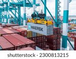 Small photo of Tanjung Pelepas, Johor, Malaysia - May 5, 2023: Maersk owned container loaded by the gantry crane on the container ship.