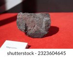 Small photo of Raw specimen of Magnetite rock stone in the Geological Museum. Mineral and Stone Museum.