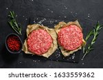 Home HandMade Raw Minced Beef steak burgers. Farm organic meat. Black background. Top view