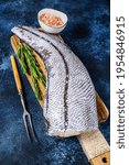 Small photo of Fresh Raw grenadier macrurus white fish on a wooden cutting board. Blue background. Top view