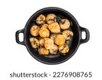 Scallops seared in garlic, thyme and butter served in cast iron skillet. Isolated on white background