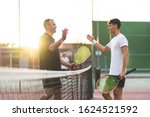Father And Son Playing Tennis...