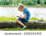 Small photo of Child boy sits slouching hunched back bent,neck,looks phone,over device.incorrect unhealthy curvature position posture,body alignment.Preventing stooping scoliosis.spine problem.Dependence on gadgets.