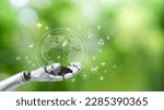Small photo of Globe and tree in robot hand with Environment icon. Green technology and Environmental technology. science artificial Intelligence and Technology. Sustainable development goal (SDGs) concept.
