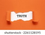 The word Truth appearing behind torn orange paper.
