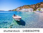 Boat on a clear transparent water in village of Loutro, Crete, Greece