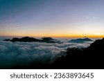 View of the sea of ​​clouds at sunset and several mountains on the Dieng plateau, Central Java, Indonesia