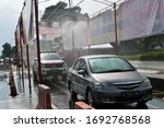 Small photo of all vehicles without exception that enter the city must pass through the disinfectant spraying chamber, to prevent corona virus transmission. Purwokerto / Indonesia - 2 April 2020