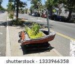 Small photo of Queens, NY - July 14 2012: Smitty's fishing boat sculpture on the center median of Cross Bay Boulevard in Broad Channel