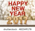 Happy New Year 2017 wood texture on marble table with sparkling bokeh wall,Holiday concept.