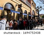 Small photo of Suzhou/China-April 2020: life returns to normal after coronavirus in China. Crowd of people wearing protective mask, waiting outside NIKE store for shopping. Retaliatory consumption concept