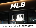 Small photo of Shanghai,China-March 11th 2022: close up Major League Baseball (MLB) sign at night. Professional baseball organization and sports league