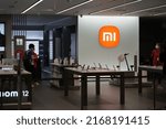 Small photo of Shanghai,China-June 8th 2022: Xiaomi electronics store with customer. A Chinese company