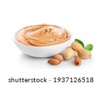 Creamy peanut butter in small bowl isolated on white background.
