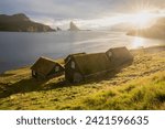 Small photo of Houses with turf roofs, Bour village, vagar island, faroe islands, denmark, europe Sunny summer view of Saksun village with typical turf-top houses. Traveling concept background.
