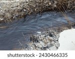 Small photo of a small river flows mightily to the sea after rain