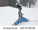 Small photo of A snowboarder on a ramp at the Wisp Ski Resort in Deep Creek Lake Maryland