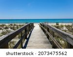 A beautiful view of a wooden path going to Henderson Beach State Park Destin in the USA