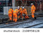 Small photo of PRESTON, UNITED KINGDOM - Nov 29, 2021: A group of railway workers working on a level crossing in Bamber Bridge, Preston