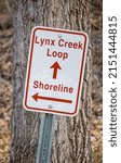 Small photo of PRESCOTT VALLEY, UNITED STATES - Apr 06, 2022: A close up of Lynx Creek Loop Sign at Fain Park in Prescott Valley, Arizona with shoreline arrow