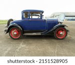 Small photo of MORON, ARGENTINA - Mar 27, 2022: Old blue Ford Model A coupe hardtop with rumble seat circa 1930 parked at an airstrip Hangars Side view CADEAA MNA 2022 classic car show Copyspace