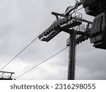A crosshead cableway support with metal cantilever arms and rollers